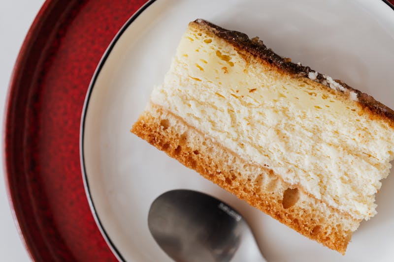 Tres Leches Cake slice with cream topping